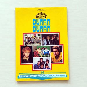 May include: A vintage yellow book titled "The Best of Duran Duran" with multiple color photographs of the band. The cover features the band's name in blue and white, and the text "24 Sensational Full Colour Photographs".