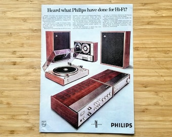 May include: Vintage advertisement for Philips Hi-Fi audio equipment. The image features a turntable, speakers, a reel-to-reel tape player, and an amplifier. The ad has the text "Heard what Philips have done for Hi-Fi?"