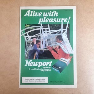 May include: Vintage Newport cigarette advertisement. The ad features two people holding white wicker chairs against a green background. Text includes "Alive with pleasure!" and "Newport". A pack of Newport cigarettes is also visible.