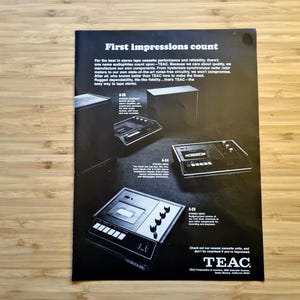May include: Black and white advertisement for TEAC stereo tape cassette decks. The ad features several models, including the A-23 and A-24, with the headline "First impressions count."