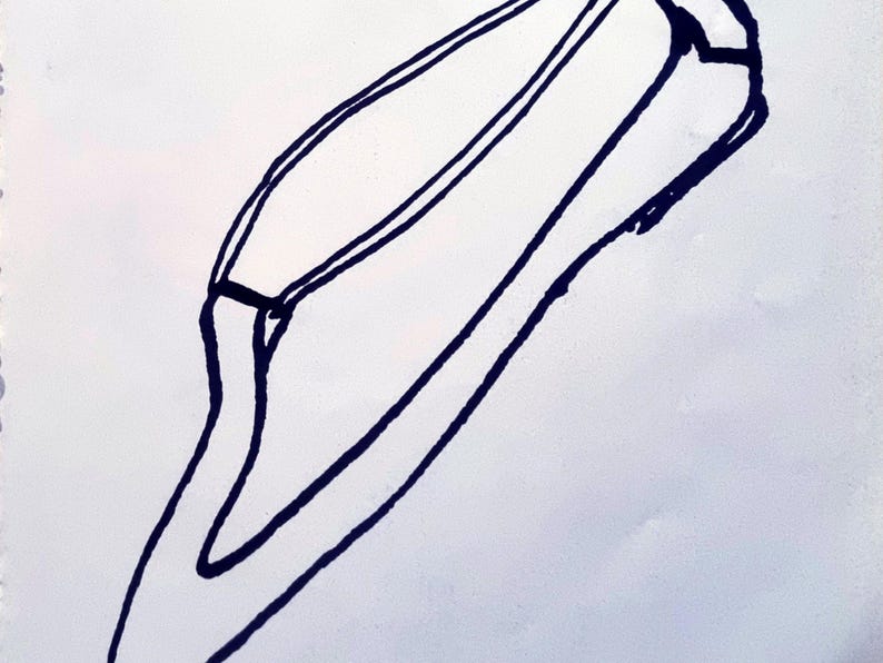 May include: A black and white line drawing of a stylized object, possibly a container or a tool. The object has a curved shape with two parallel lines running along its length, and a small rectangular detail near the top.