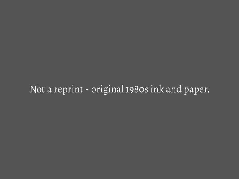 May include: Dark gray background with the text "Not a reprint - original 1980s ink and paper." in white. The text suggests a vintage or retro item, possibly a print or document from the 1980s.