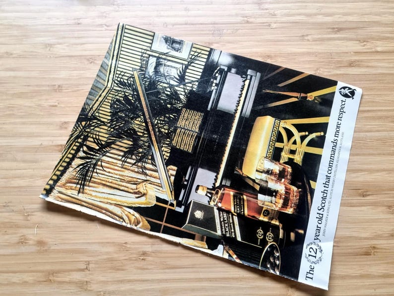 May include: An advertisement featuring a bottle of Black Label Scotch whisky. The image has a black, gold, and brown color scheme, with text that reads "The 12 year old Scotch that commands more respect."