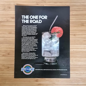May include: An advertisement for Kryptonics wheels, featuring a cocktail with ice and a red garnish. The text reads "THE ONE FOR THE ROAD" and describes the wheels' features for outdoor skating.