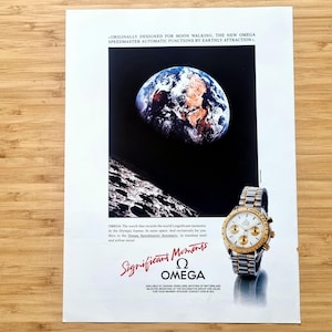 May include: An advertisement featuring an Omega Speedmaster watch with a gold and silver band. The background shows an image of Earth and the moon. Text includes "Significant Moments" and "OMEGA".