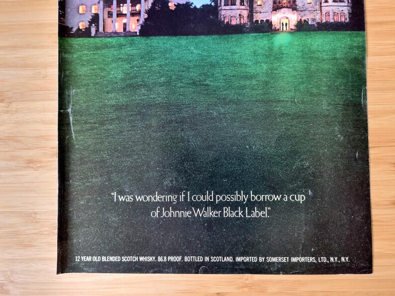 May include: An advertisement featuring a green lawn in front of a large building at dusk. The text reads, "I was wondering if I could possibly borrow a cup of Johnnie Walker Black Label."