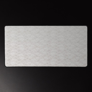 May include: A rectangular, silver desk mat featuring a repeating wave pattern. The mat has rounded corners and a smooth surface. The wave design is a lighter shade of silver, creating a subtle contrast against the base colour.