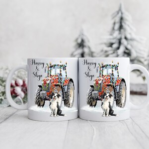 May include: White ceramic mug featuring a red tractor decorated with Christmas lights and a black and white dog. The mug has the names "Harry & Skye" in elegant script. The design is set against a snowy background.