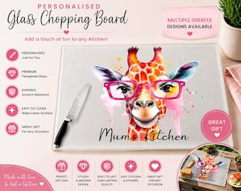 Op de afbeelding: Een rechthoekige glazen snijplank met een kleurrijke aquarelillustratie van een giraf met een felroze bril. De tekst Mums Kitchen staat onder de giraf gedrukt. Een zilveren keukenmes met een zwart handvat ligt op de snijplank.