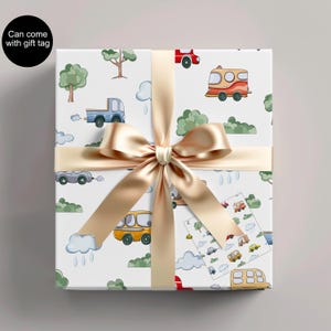 May include: A wrapped gift with a white background featuring a pattern of colorful cartoon vehicles, trees, and clouds. The gift is tied with a gold satin ribbon and bow. A small gift tag with matching illustrations is attached.