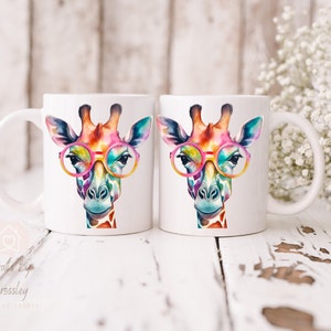 May include: Two white ceramic mugs with a colorful giraffe wearing pink glasses design. The giraffe has a watercolor effect and is looking directly at the viewer.