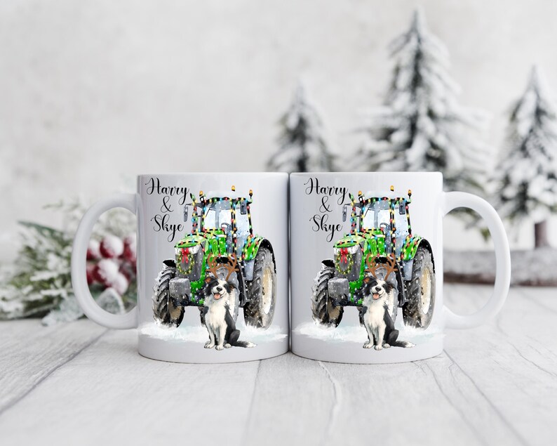 May include: Two white ceramic mugs with a festive design. Each mug features a green tractor decorated with Christmas lights, a black and white dog, and the names "Harry & Skye" in elegant script. The mugs are set against a snowy winter backdrop.