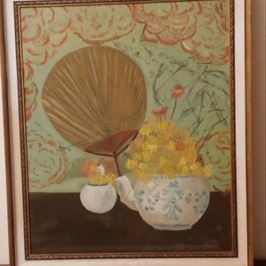 May include: A painting of a still life with a large, brown fan, a teapot, and a small vase filled with yellow flowers. The background is a green and orange floral pattern.