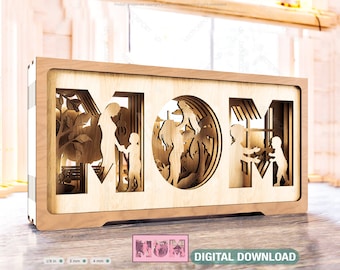 May include: A wooden cutout of the word "MOM" with a silhouette of a mother and two children inside each letter. The cutout is a light brown color and has a rustic look.