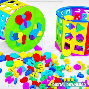 May include: A colorful shape sorter toy with a cylindrical design. The toy features various shapes and letters, with matching blocks scattered around. The sorter has a green, yellow, blue, and red color scheme, with the text "DIGITAL DOWNLOAD" at the bottom.