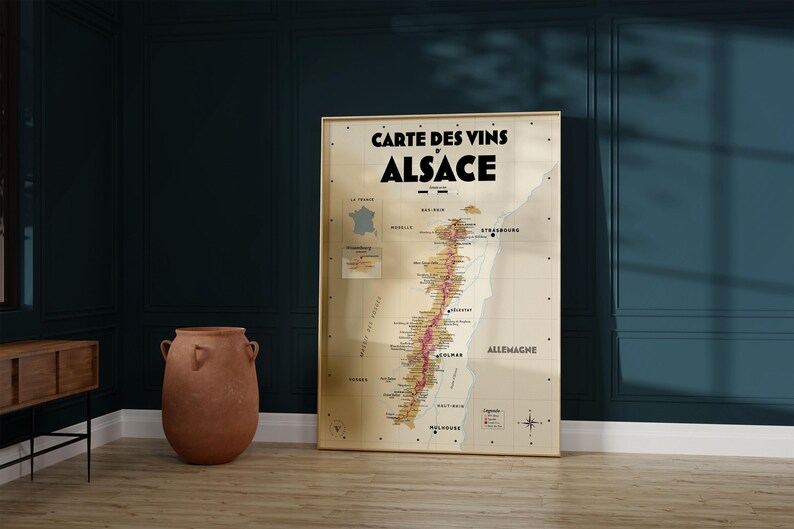 May include: A vintage-style map of the Alsace wine region in France. The map is printed on a beige background with brown and red lines indicating the different wine-producing areas. The title "Carte des Vins d'Alsace" is printed in black at the top of the map.