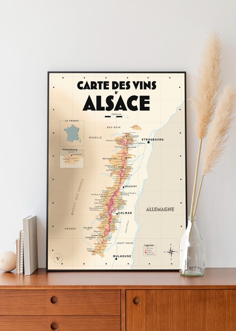 May include: A vintage-style map of the Alsace wine region in France. The map shows the different wine-producing areas, including the cities of Strasbourg, Colmar, and Mulhouse. The map is printed on a cream-colored background with black and red text.