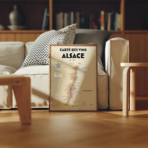 May include: A vintage-style map of the Alsace wine region in France. The map is printed on a cream-colored background with brown borders and text. The map shows the different wine-producing areas of the region, with labels in French.