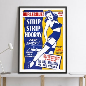 Op de afbeelding: Een ingelijste vintage burlesque poster met een retro design. De poster toont een vrouw in een blauwe bh en jarretelgordel, met de tekst "Strip Strip Hooray" en "Big Time Burlesque on the Screen."