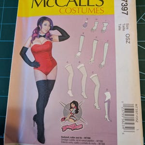 May include: McCall's Costumes pattern M7397. The package features a woman in a red bodysuit, black gloves, and thigh-high boots. Includes illustrations of costume components and the text "Bodysuit, collar and tie - M7398".