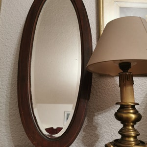 Old narrow oval beveled mirror France