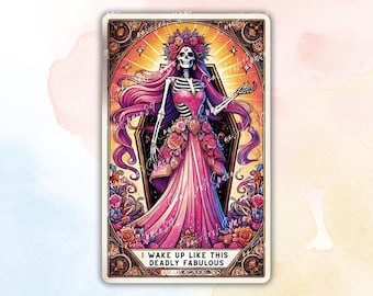 May include: A decorative card featuring a skeleton figure in a pink dress and floral crown. The image has a vibrant color palette with pink, purple, and gold hues. Text at the bottom reads "I WAKE UP LIKE THIS DEADLY FABULOUS."
