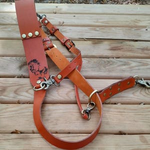 May include: A white ceramic mug with a black handle and the text "But First, Coffee" in a black, handwritten-style font. The mug is on a white surface.