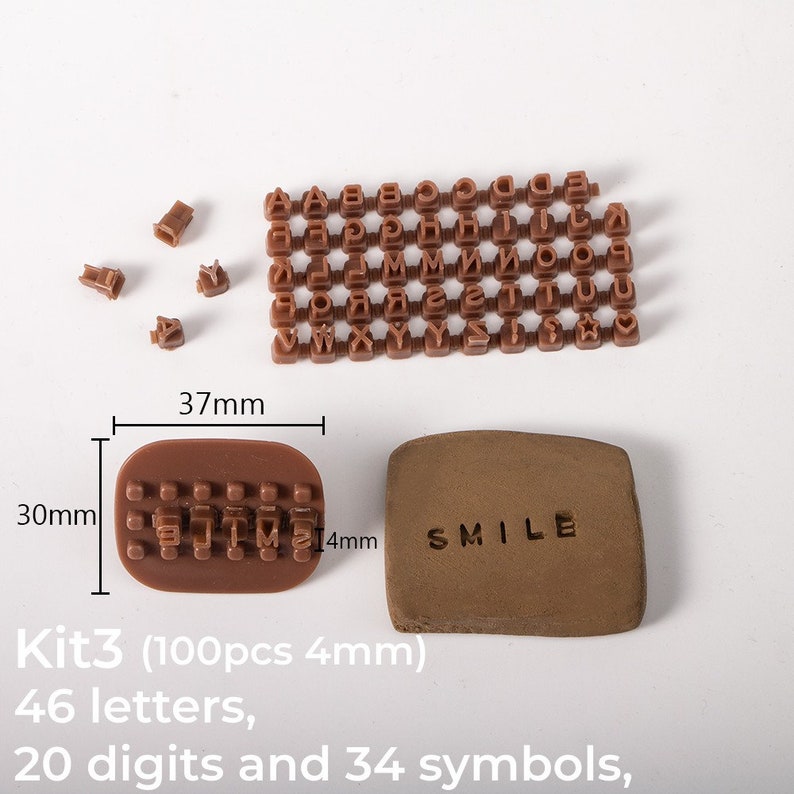 May include: A set of 100 brown plastic letter and number stamps in a kit. The stamps are 4 mm in size and include 46 letters, 20 digits, and 34 symbols. The kit also includes a brown plastic stamp holder and a brown clay tile with the word "SMILE" stamped on it.