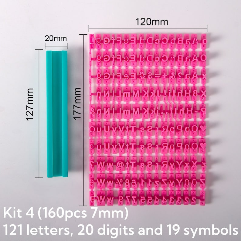 May include: A set of 160 pink letter and number stamps in a plastic case. The stamps are arranged in a grid and measure 7 mm each. The case is 12.7 cm tall and 17.7 cm wide. The set includes 121 letters, 20 digits, and 19 symbols.