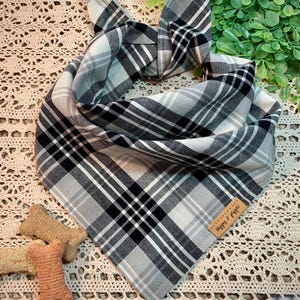 May include: A black and white plaid bandana with a brown tag that says "Happy & Co."