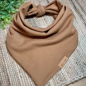 May include: A brown waffle knit bandana with a small brown leather tag that says "shop & fig" in white script.
