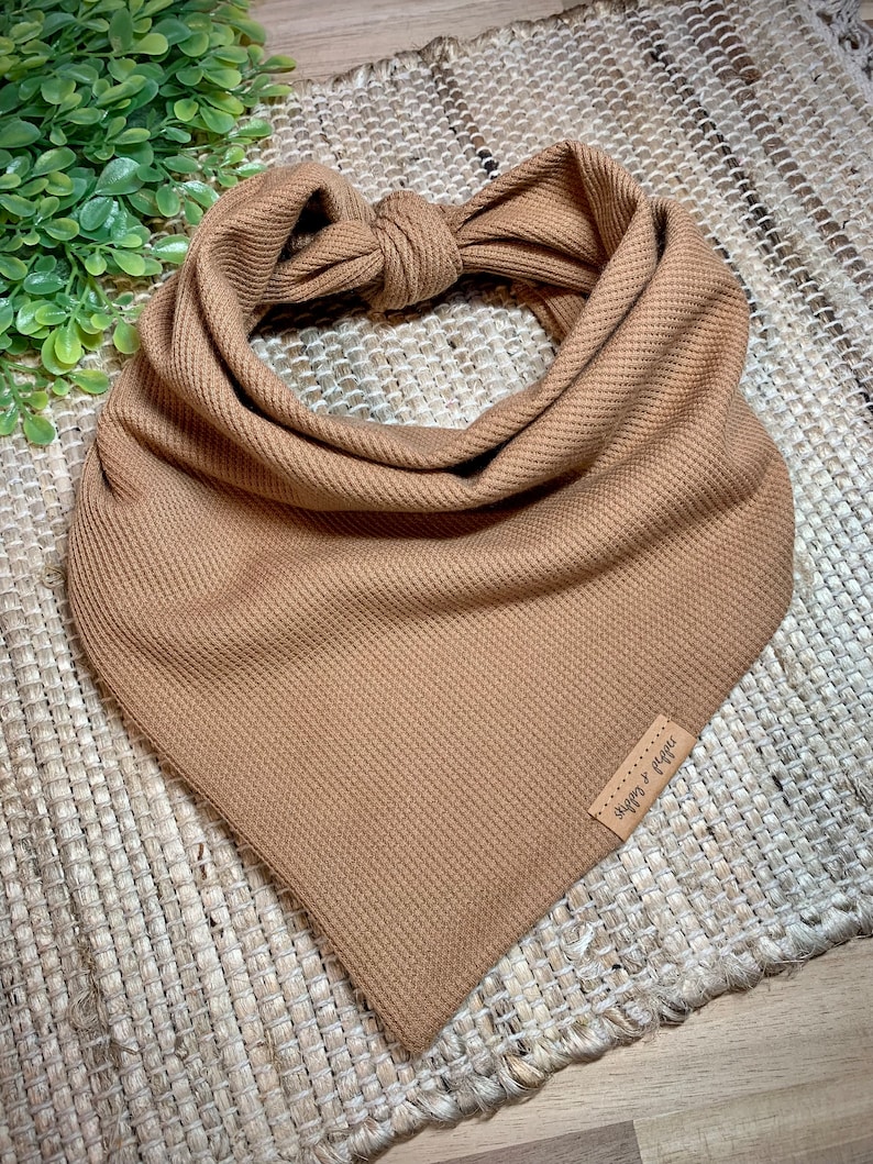 May include: A brown waffle knit bandana with a small brown leather tag that says "shop & fig" in white script.