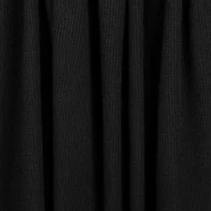 May include: Black fabric with a textured, ribbed surface. The fabric is draped and folded, creating soft folds and shadows.