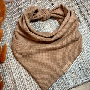 May include: A brown waffle knit bandana with a brown leather tag that says "Happy Camper".