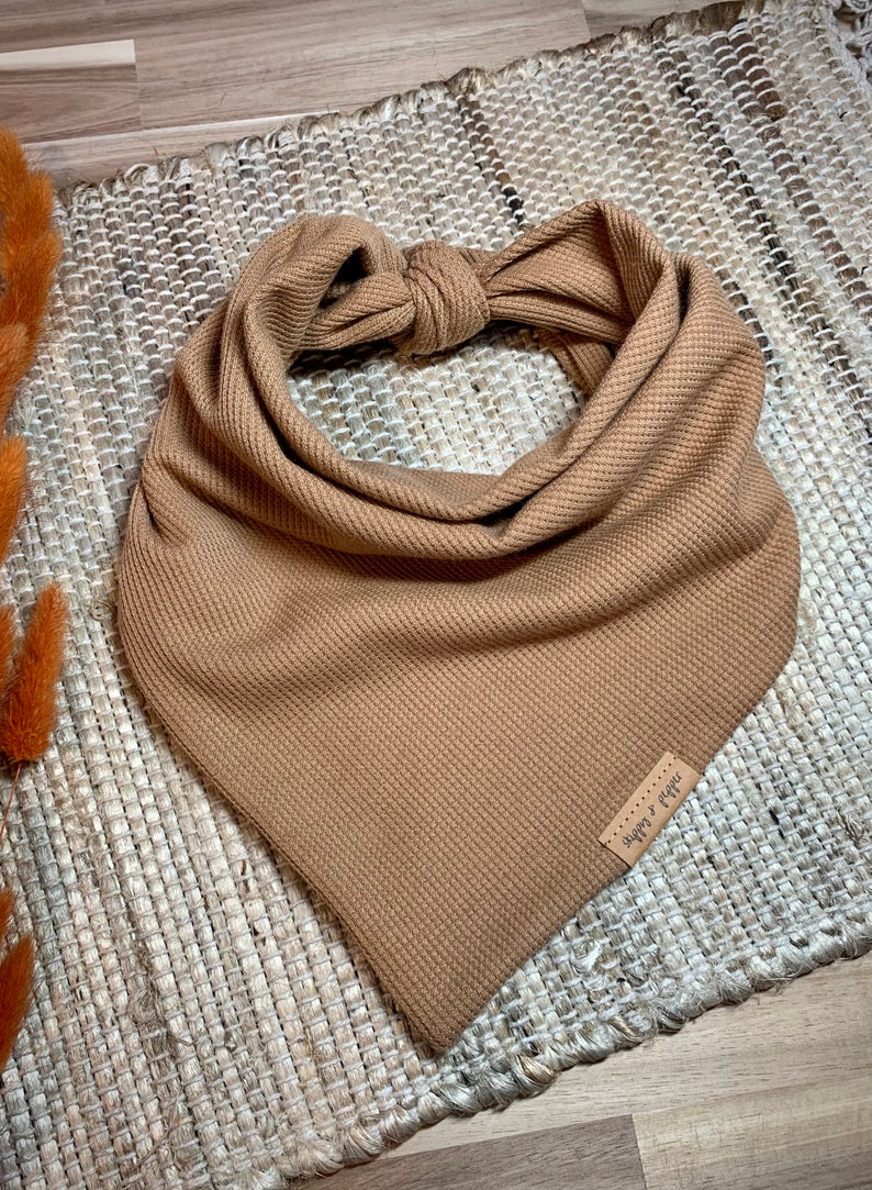 May include: A brown waffle knit bandana with a brown leather tag that says "Happy Camper".