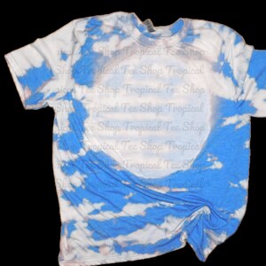 May include: A blue and white tie-dye t-shirt with a white circle in the center. The shirt is made of a soft, comfortable material and is perfect for everyday wear.