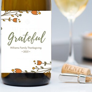 May include: A white wine bottle label with a floral design and the text "We are Grateful" with the Williams Family Thanksgiving 2021.