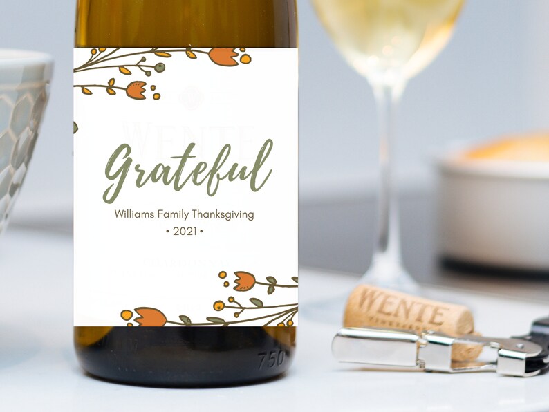 May include: A white wine bottle label with a floral design and the text "We are Grateful" with the Williams Family Thanksgiving 2021.