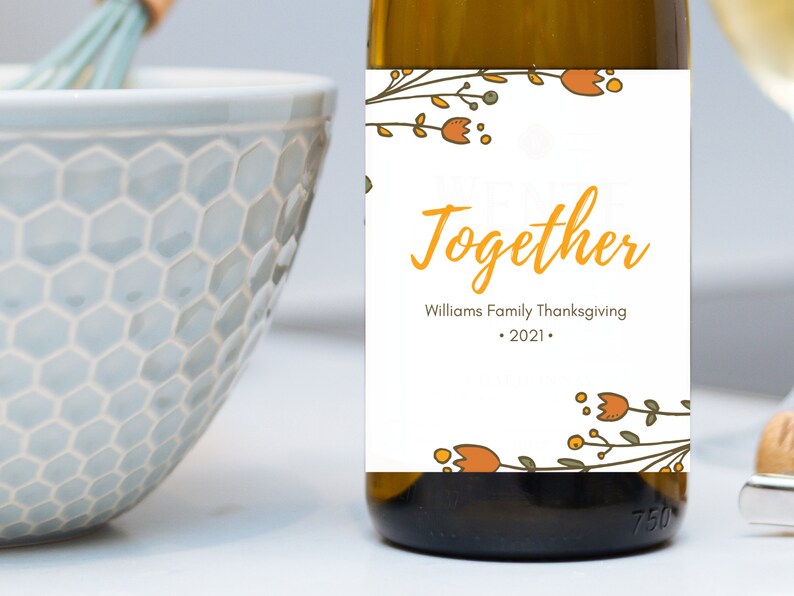 May include: A white wine bottle with a label that says "We're Better Together" with a floral design and the text "Williams Family Thanksgiving - 2021 - "