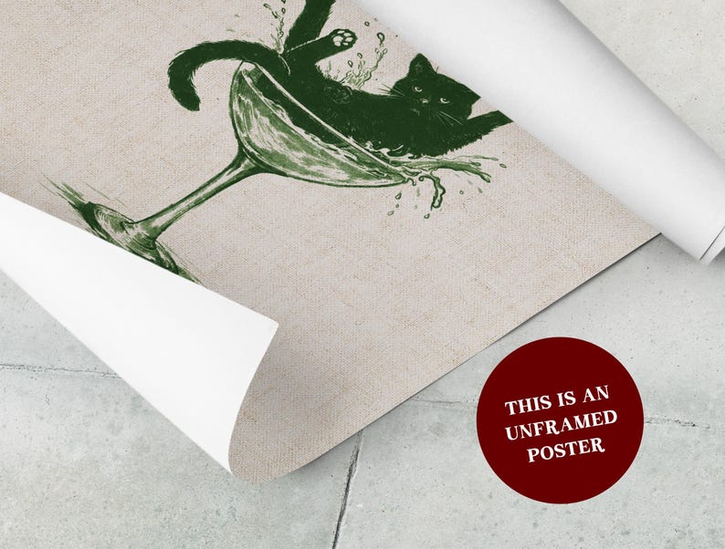 May include: An unframed poster featuring a green illustration of a black cat lounging in a martini glass with water splashing out. The poster has a beige background and a red circle with white text that reads "THIS IS AN UNFRAMED POSTER".