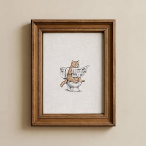 Könnte beinhalten: Ein gerahmter Kunstdruck mit einer detaillierten Illustration einer orangefarbenen getigerten Katze, die auf einer weißen Toilette sitzt und eine Zeitung liest. Das Bild befindet sich in einem dunkelbraunen Holzrahmen mit cremefarbenem Passepartout.