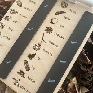 A clipboard with a list of various plant and animal species, along with illustrations of each species, is shown in the image.