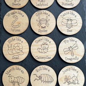 May include: Twelve wooden circles with different animal illustrations and text describing how to move like that animal.  The text includes "Boogie like a Beetle", "Twirl like a Ladybird", "Wiggle like a Worm", "Spin like a Spider", "Flutter like a Butterfly", "Dance like a Bee", "Slide like a Snail", "Crawl like a Catterpillar", "Fly like a Dragonfly", "March like an Ant", "Roll like a Woodlouse", and "Jump like a Grasshopper".