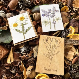 a couple of cards sitting on top of a pile of leaves