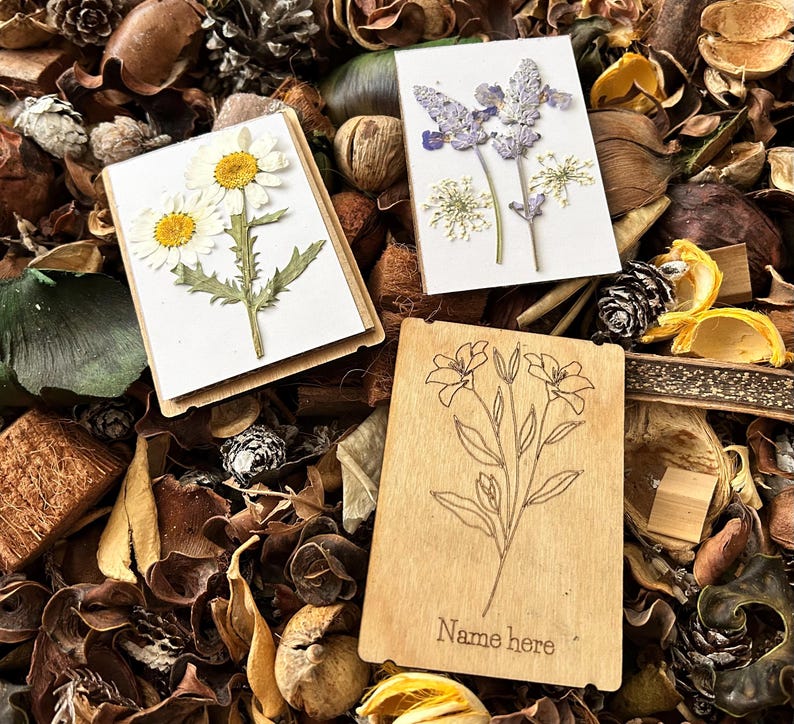 a couple of cards sitting on top of a pile of leaves