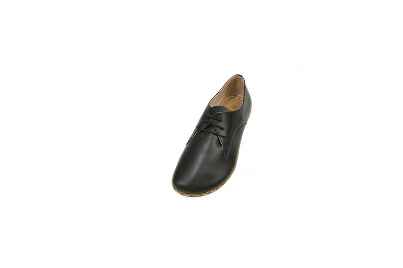 May include: Black leather lace-up shoes with a brown sole.
