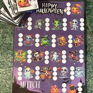 May include: A purple Halloween game board featuring the text Happy Halloween and Match & Save, decorated with various cartoon characters like ghosts, skeletons, and pumpkins. A stack of matching game cards with numbered icons sits on top.