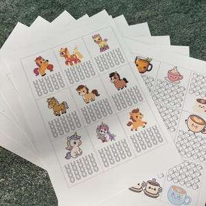 May include: Multiple printed sheets displaying colourful cartoon horses and unicorns, alongside coffee and tea-themed illustrations. The sheets have a grid pattern with horseshoe graphics. The images are stacked on top of each other.