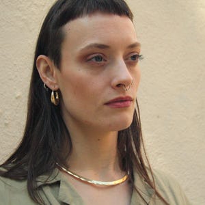 This golden brass choker is more than just jewelry — it’s a statement. With Celtic and Viking roots, its minimalist design celebrates strength and beauty. Lightweight, handcrafted, and perfect for those who embrace bold and symbolic style.