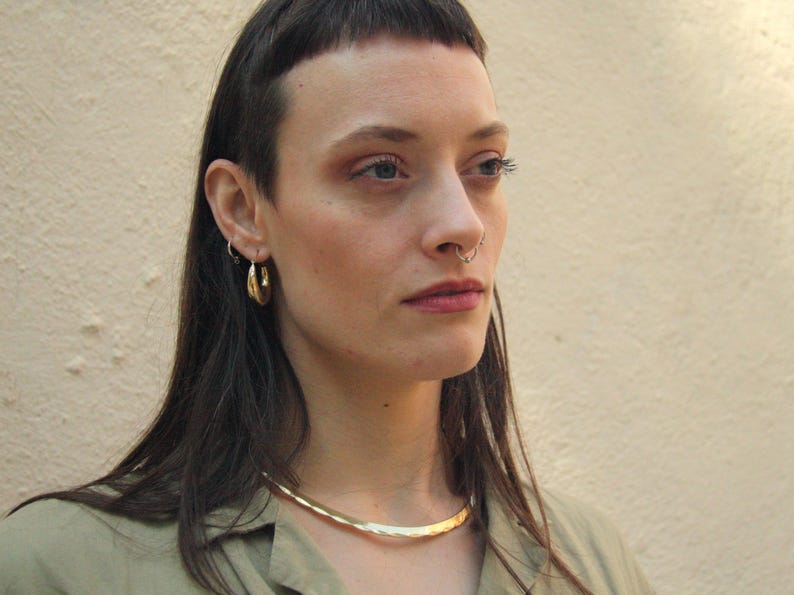 This golden brass choker is more than just jewelry — it’s a statement. With Celtic and Viking roots, its minimalist design celebrates strength and beauty. Lightweight, handcrafted, and perfect for those who embrace bold and symbolic style.